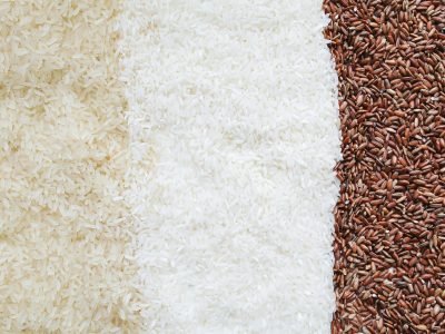 Three types of uncooked rice in a close-up still life arrangement.